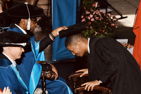 Iviwe receiving his graduation cap on stage